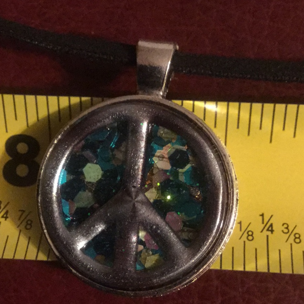 1 inch resin Peace sign, 16 inches vegan rope.